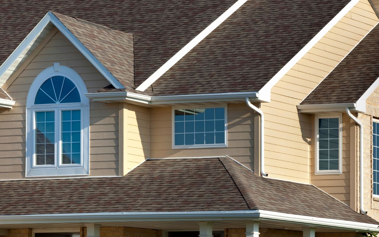 Beige vinyl siding on a traditional two-story home