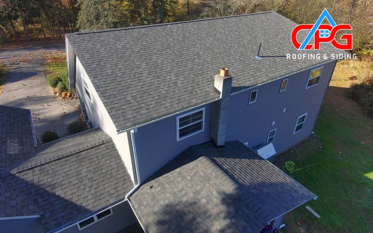 Inspector checking attic for early signs of a roof leak