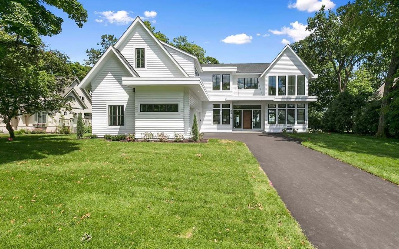Home with Sherwin Williams beige siding and dark shutters