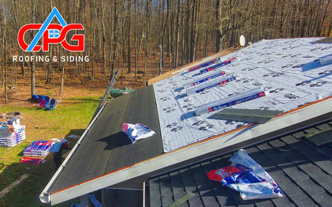 Torn shingles on roof after wind and hail storm